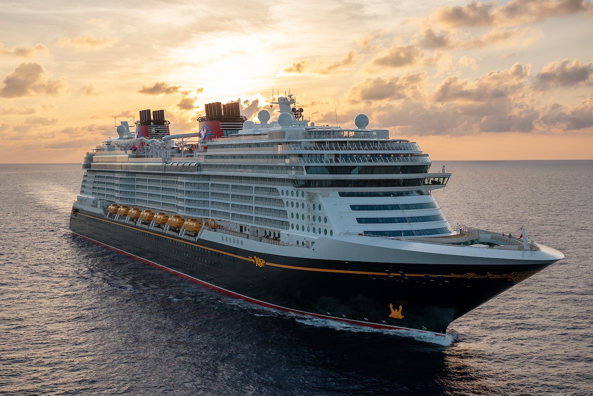70th Castle Art A cruise ship, in the style of a classic ocean liner, moves across the ocean, with a bright sunset just behind the ship.