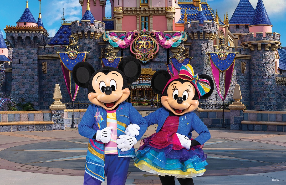 ProjectOrange A smiling mother and two young children happily walk around Disney's Grand Floridian Resort & Spa.