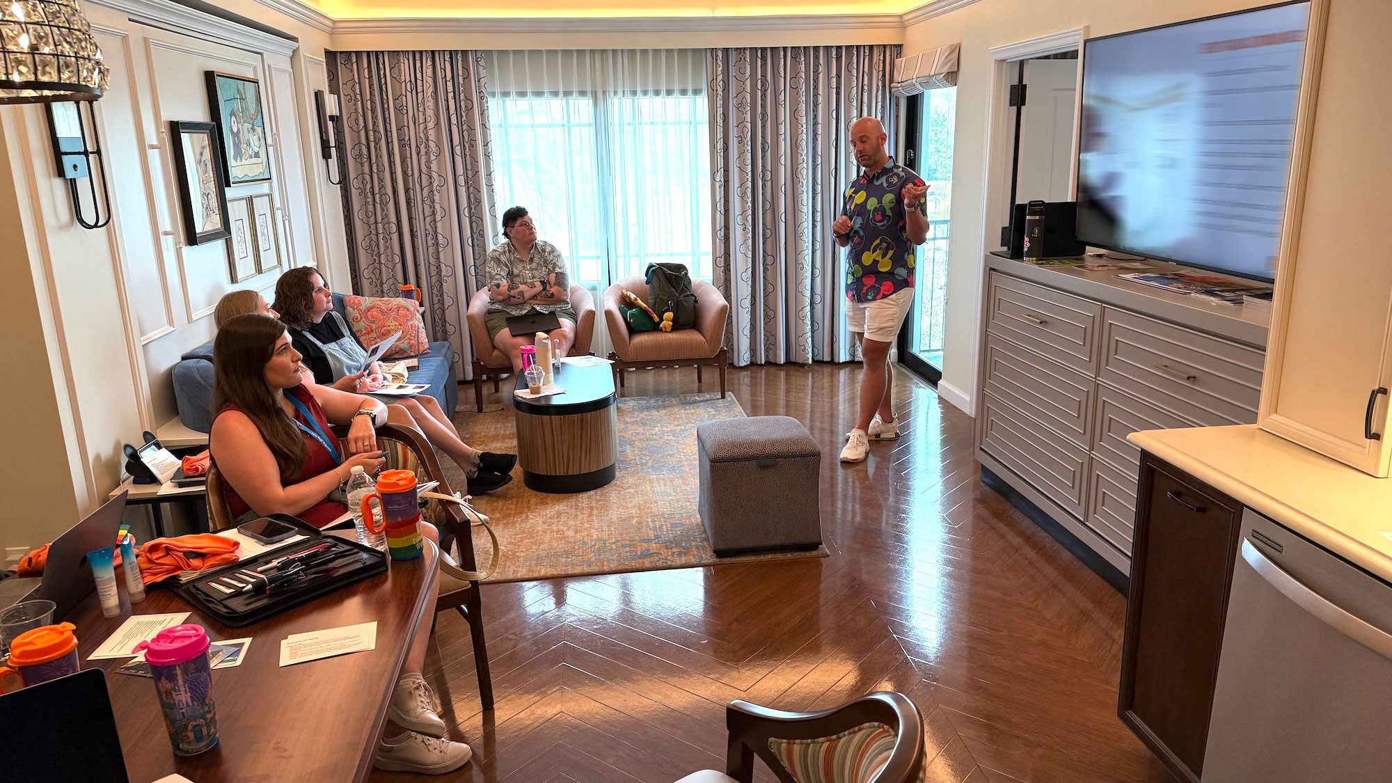 A group of Extra Magic Trips Vacation Planners in a villa at Disney's Riviera Resort attending the Magical Summit training seminar.